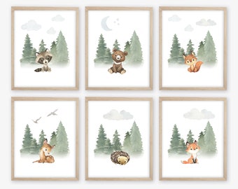 May include: Set of six watercolor prints featuring woodland animals in a forest setting. The animals include a raccoon, bear, fox, deer, hedgehog, and another fox. Each print has a light blue background with clouds and trees.