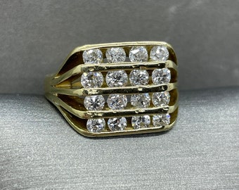 May include: A gold ring with a rectangular setting featuring multiple rows of round diamonds.