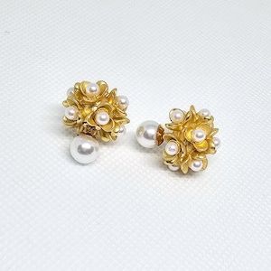 May include: A pair of gold earrings with a cluster of pearl-like beads in the centre of each earring. The earrings are shaped like a flower.
