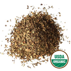 May include: A pile of dried, chopped herbs, likely for culinary use, against a white background. The herbs are primarily brown and green, with a variety of leaf sizes. A USDA Organic seal is visible in the lower right corner.