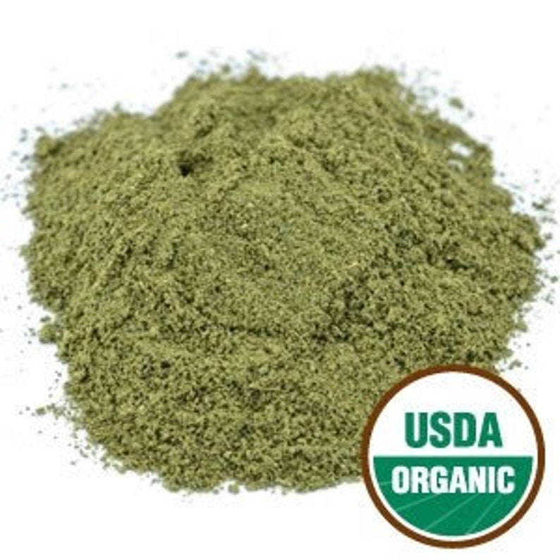 May include: A close-up of a pile of dried, green, organic herb powder. The powder is finely ground and has a uniform texture. The USDA Organic seal is visible in the lower right corner of the image.