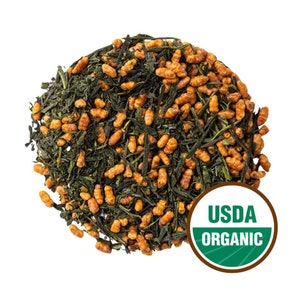 May include: A close-up of a pile of green tea leaves and brown rice crisps. The tea is USDA Organic certified.