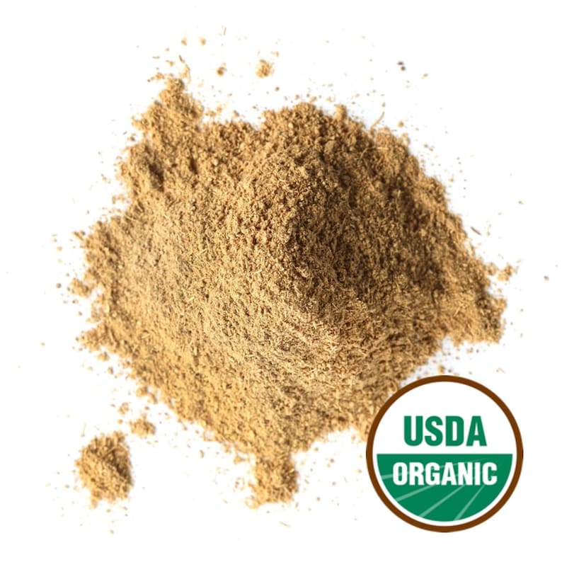 May include: A pile of light brown powder, possibly a spice or herb, against a white background. The USDA Organic seal is visible in the lower right corner, indicating organic certification. The powder appears finely ground and textured.