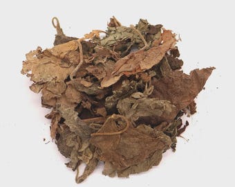 May include: A pile of dried, brown and green leaves. The leaves have a variety of shapes and sizes, with some curled and others flat. The leaves are a mix of light and dark brown, with some green hues.