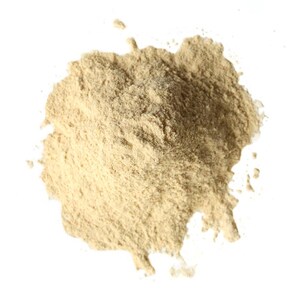 May include: A close-up of a pile of light brown powder on a white background. The powder has a fine texture and appears to be a natural substance. The powder is scattered in a circular shape.