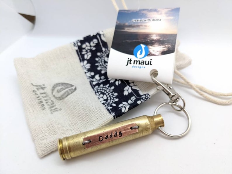 comes in a fabric gift bag. current color of bag is neutral tan. brass casing with copper plate. Example shown is a gift for daddy, great gift for men, with custom word or name of your choice.