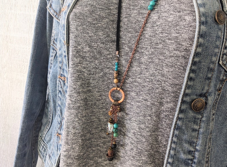 Long boho style necklace with solid copper one inch cirlce and multiple dangles in turquoise and lava, and quality glass crystal and wood.