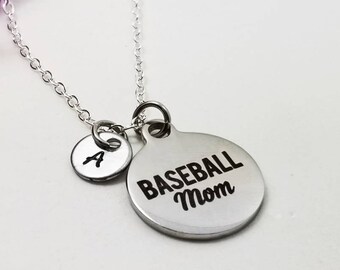 May include: Silver necklace with a round pendant that says "Baseball Mom". A smaller round charm with the letter "A" hangs above the pendant.