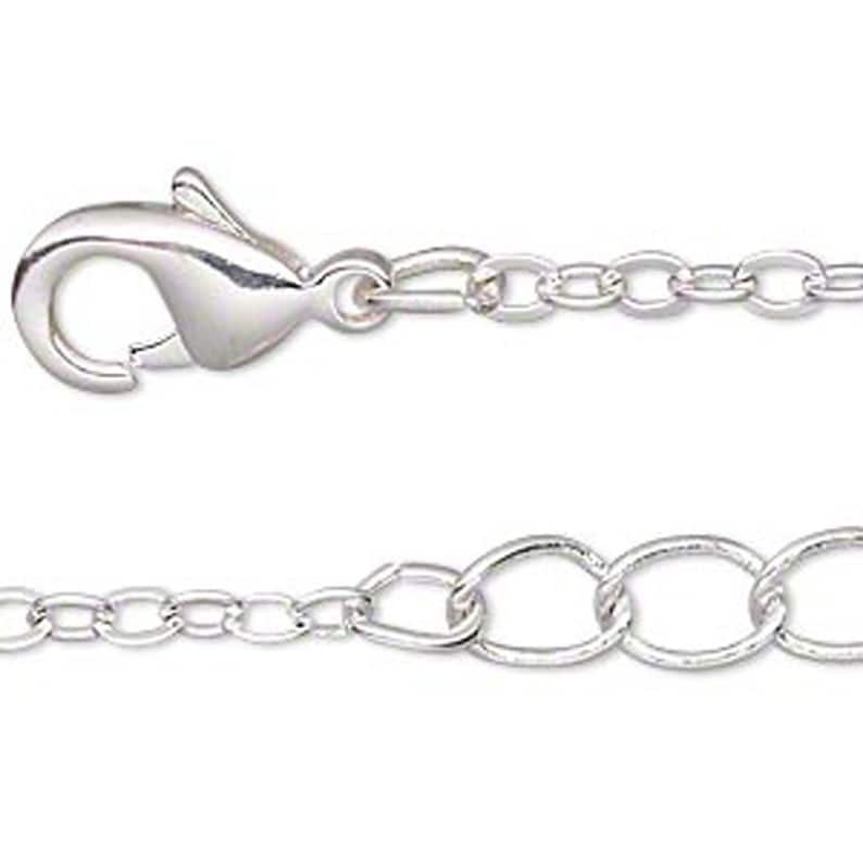 May include: Silver chain with a lobster clasp. The chain is made of small, oval-shaped links.