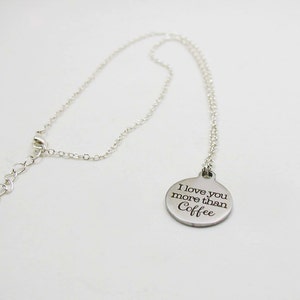 May include: A silver necklace with a round pendant that says "I love you more than Coffee".