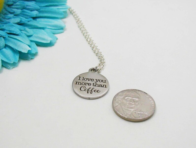 May include: Silver necklace with a round pendant that says "I love you more than coffee".