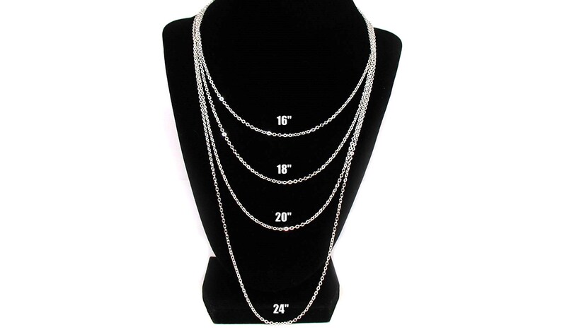 May include: Four silver chains of different lengths displayed on a black mannequin. The chains are 16 inches, 18 inches, 20 inches, and 24 inches long.
