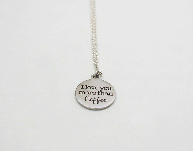 May include: Silver necklace with a round pendant that says "I love you more than coffee".