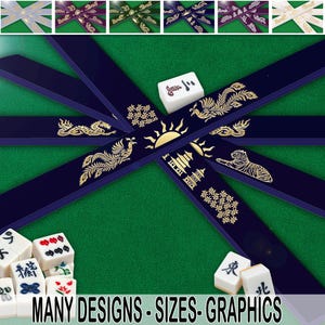 May include: A green felt surface with a variety of Mahjong tiles and decorative navy blue ribbons. The ribbons feature gold illustrations of dragons, phoenixes, and other symbols. The text "MANY DESIGNS - SIZES - GRAPHICS" is at the bottom.