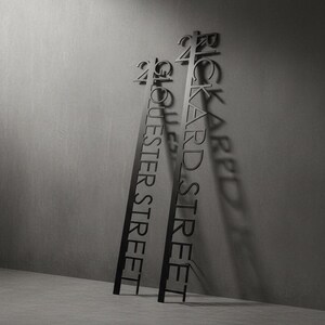 Metal Art House Sign - Stainless Steel Construction and Industrial powder coating shown in an AI-generated listing photo