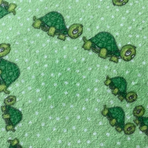 Fitted crib sheet with green turtle families in flannel, ready to ship free in 24 hours