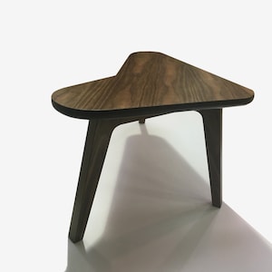 May include: A triangular wooden side table with a dark brown wood finish and three legs.
