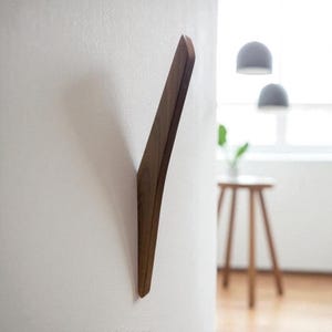 Single Walnut coat hook. Modern design with easy install.