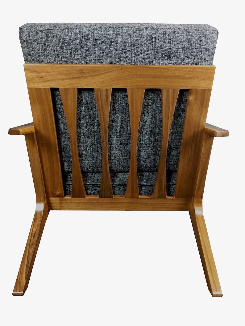 May include: A gray fabric armchair with a wooden frame and a slatted back. The chair has a mid-century modern design.