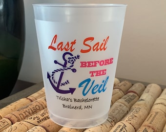 May include: A white plastic cup with a blue anchor and the text "Last Sail Before The Veil" in pink, orange, and blue. The text "Trisha's Bachelorette Brainerd, MN" is printed below the anchor.