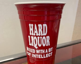 May include: A red plastic cup with a white rim and the text "HARD LIQUOR MIXED WITH A BIT OF INTELLECT" printed on the side.