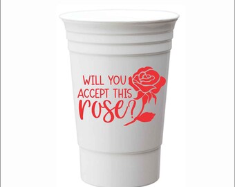 May include: White plastic cup with the text "Will you accept this rose?" in red lettering and a red rose graphic.