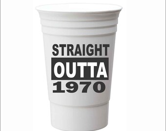 May include: White plastic cup with black text that reads "STRAIGHT OUTTA 1970".