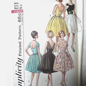 May include: Vintage Simplicity printed sewing pattern, number 4984, featuring illustrations of five different dresses. The pattern includes a size 14 with a 34-inch bust. The dresses are in various styles and colors, including yellow, black, and floral prints.