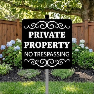 May include: A rectangular black sign with white text that reads PRIVATE PROPERTY NO TRESPASSING. The sign features decorative white scrollwork at the top and bottom edges and is mounted on a single gray metal stake centered at the bottom.