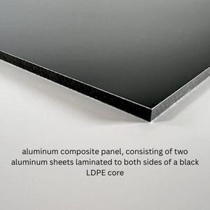 May include: An aluminium composite panel featuring a smooth black surface and a visible black LDPE core sandwiched between two thin aluminium sheets. The text reads: aluminium composite panel, consisting of two aluminium sheets laminated to both sides of a black LDPE core.