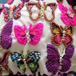 close up of beaded embroidered butterfly bikini fabric