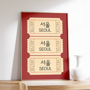 May include: A framed print with three vintage-style tickets that say "Seoul" in Korean and English. The tickets are on a red background.