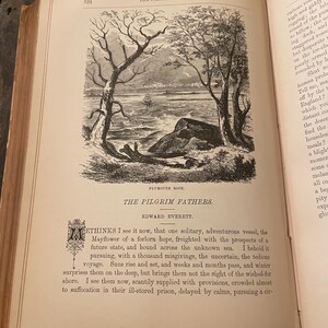 May include: A black and white illustration of a ship sailing on the water. The ship is surrounded by trees and a rocky shore. The text "PLYMOUTH ROCK" is printed below the image.