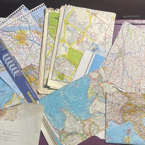 May include: A collection of vintage maps, including a map of the United States, a map of the world, and a map of the state of Maryland. The maps are in various shades of blue, green, and brown.
