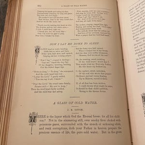 May include: A vintage book with yellowed pages and a text excerpt from the poem "Now I Lay Me Down to Sleep." The poem is about a child praying before bed. The book is open to a page with the title "A Glass of Cold Water" and the author J.B. Gough.