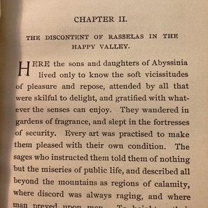 May include: A page from a book titled "The Discontent of Rasselas in the Happy Valley." The text describes the sons and daughters of Abyssinia who live in a valley where they are shielded from the hardships of the outside world.