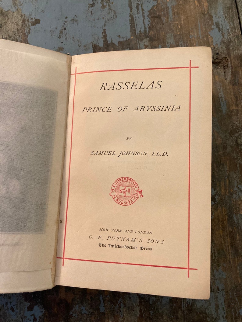 May include: A vintage book titled "Rasselas, Prince of Abyssinia" by Samuel Johnson, LL.D. The book is published by G.P. Putnam's Sons, The Knickerbocker Press, New York and London.