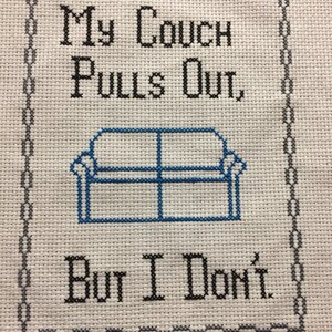 May include: Cross-stitch embroidery with a black frame and the text "My couch pulls out, but I don't."