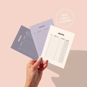 May include: Three printable reading log sheets with the word "READS" at the top. The sheets are in different colors: purple, light purple, and white. The sheets have columns for book title, author, and rating.