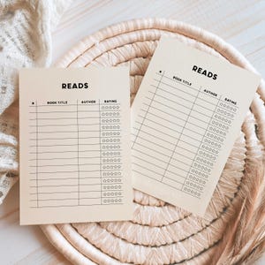 May include: Two beige printable reading log sheets with the word "READS" at the top. Each sheet has columns for book title, author, and rating. The rating column has five stars for each row.