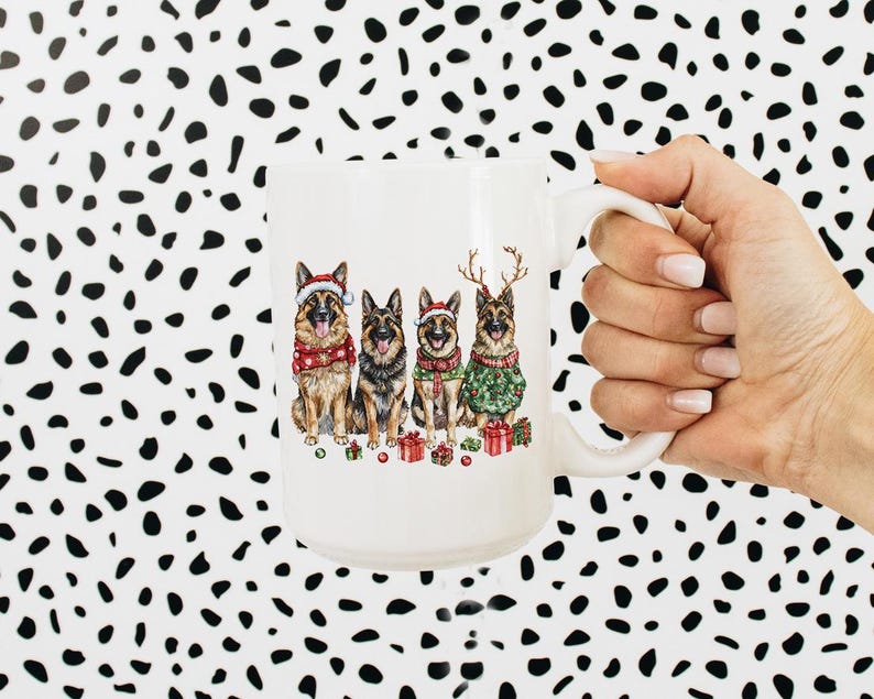 May include: White ceramic mug with a Christmas-themed design featuring four German Shepherd dogs wearing Santa hats and reindeer antlers. The dogs are sitting in a row and holding presents.