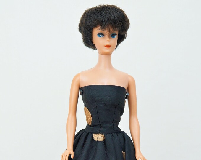 Featured listing image: 1961 Mattel Raven Bubble Cut Barbie No. 850 With Black and Gold Gown