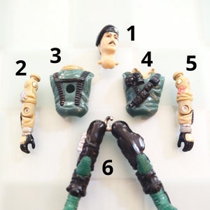 May include: A set of six plastic action figure parts in green, black, and tan. The parts include a head, torso, legs, and two arms.