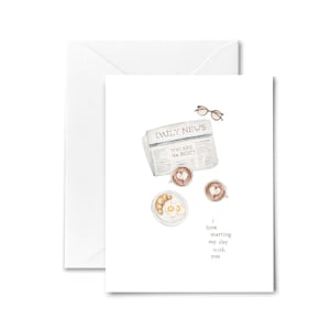 May include: A watercolor illustration of a breakfast scene with a newspaper, coffee, croissants, and eggs. The newspaper headline reads "DAILY NEWS" and "YOU ARE THE BEST!" The text below the illustration reads "I love starting my day with you."