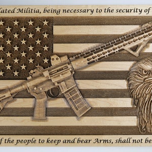 May include: A wooden plaque with an American flag design, a rifle, and an eagle. The text "A well regulated Militia, being necessary to the security of a free State, the right of the people to keep and bear Arms, shall not be infringed." is engraved on the plaque.