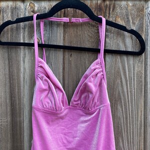 May include: A pink velvet halter top with a V-neckline.