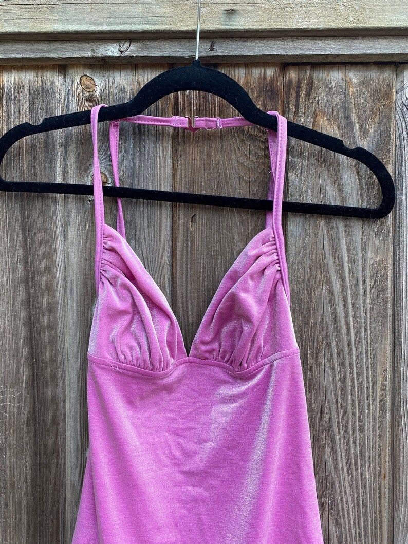 May include: A pink velvet halter top with a V-neckline.