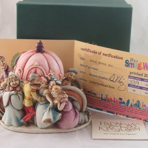 May include: A hand-painted ceramic figurine of the "it's a small world" ride from Disneyland. The figurine depicts a pink and white carriage with characters from the ride. The figurine is made by Harmony Kingdom and is numbered 339 out of 410.