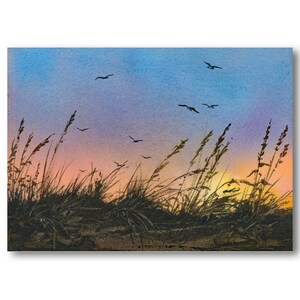 May include: A watercolor painting of a sunset over a field of tall grass with birds flying in the sky. The sky is a gradient of blue, pink, and orange. The grass is silhouetted against the sunset.