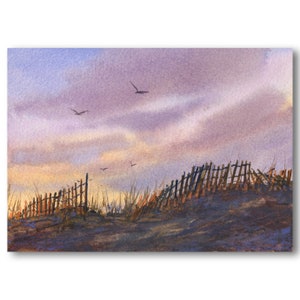 May include: A watercolor painting of a wooden fence along a sandy beach with a purple and orange sky.  There are several birds flying in the sky.